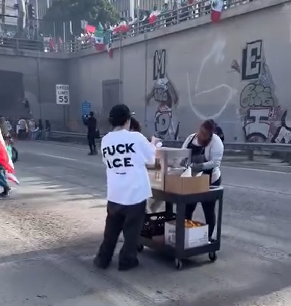 Street vendor selling hotdogs during freeway blockade.
