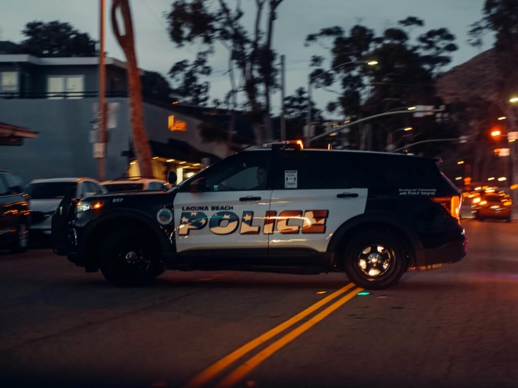 Police car parked on a quiet city street at dawn, symbolizing law enforcement response to the Viral Cincinnati Violence.