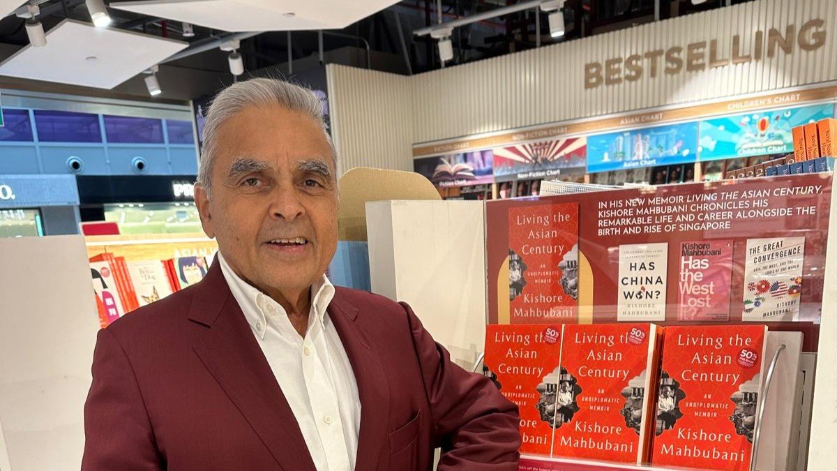 Kishore Mahbubani standing beside a bookshelf, a former Singaporean diplomat known for his views on global governance and UN reforms.