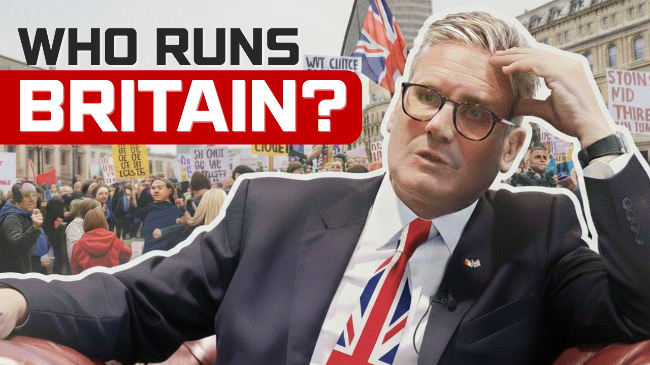 A British political leader sits thoughtfully during ongoing street protests in the UK, with crowds holding placards and flags in the background.
