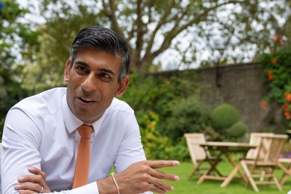 Rishi Sunak at a professional event, discussing strategy and global initiatives