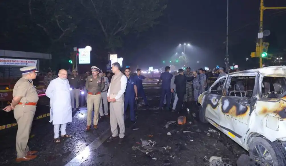 Security personnel inspect the blast site near Red Fort Metro Station during the Delhi Blast investigation.