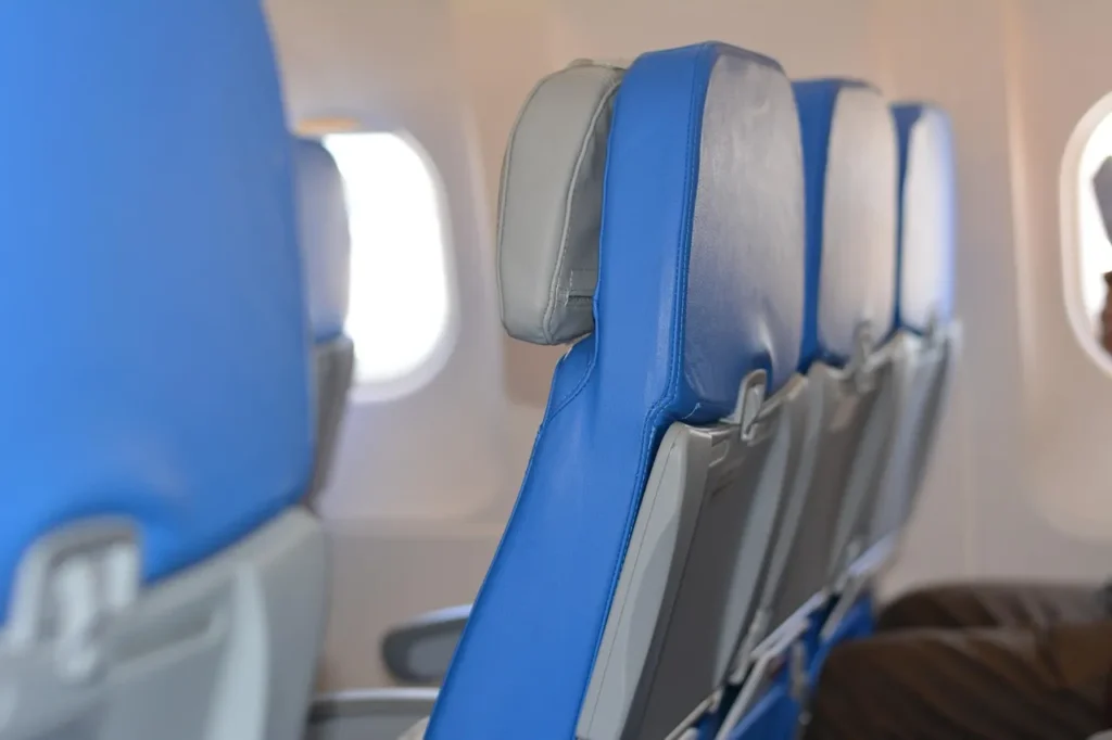 Empty blue airplane seats inside a cabin, symbolizing the travel disruption caused by the Blue Islands flight suspension.