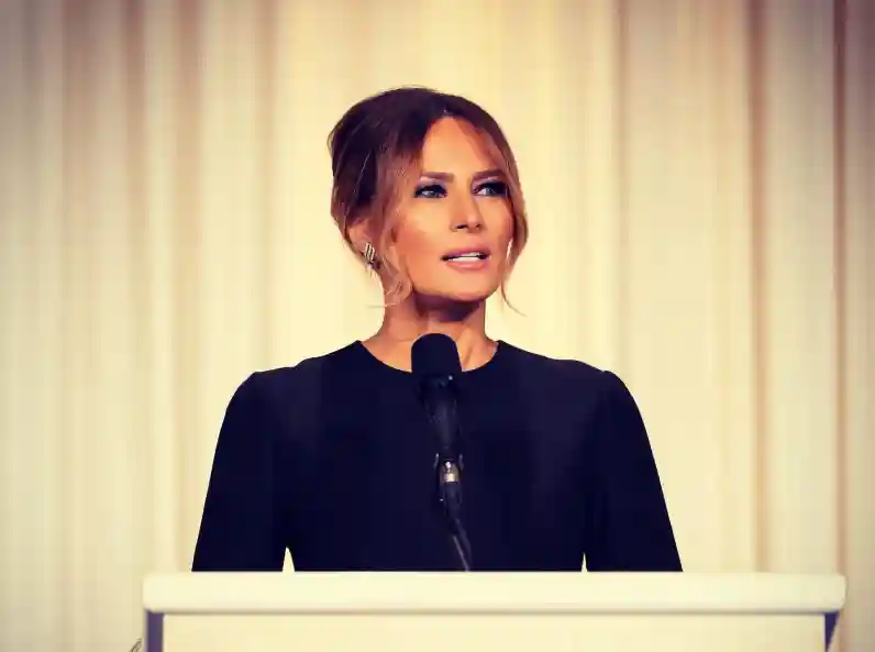Melania Trump standing on stage receiving the Patriot of the Year award