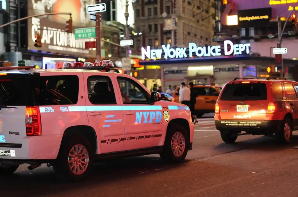 NYPD patrol vehicles parked in Times Square at night, representing police presence in the city as Mamdani retains Jessica Tisch.