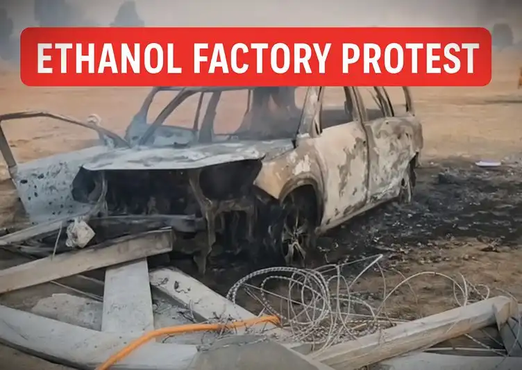 Burnt vehicle and debris at the Hanumangarh ethanol factory protest site after clashes between farmers and police.