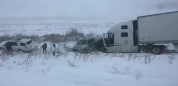 Michigan highway crash involving a semi-truck and multiple vehicles during severe winter conditions