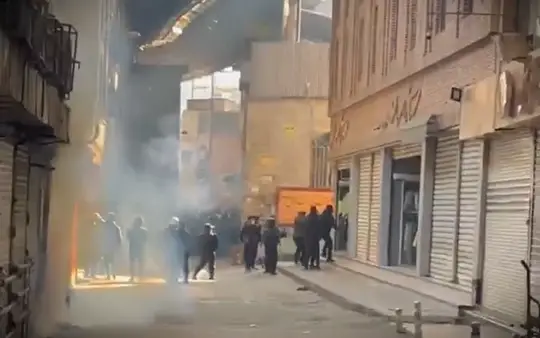 Security forces confront protesters amid smoke during Tehran Bazaar clashes inside the Grand Bazaar in Tehran, Iran.
