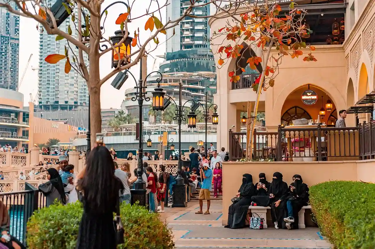 Public space in the UAE with people gathered near modern buildings, reflecting social and cultural life amid the UAE UK scholarship ban.