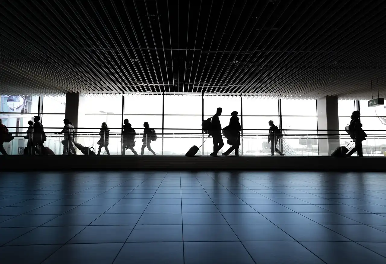 Passengers walking inside an airport terminal during the Gatwick Airport gun arrest security alert