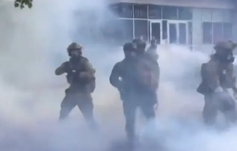 Federal agents move through tear gas during a protest outside a Portland ICE facility amid the ICE tear gas ban controversy