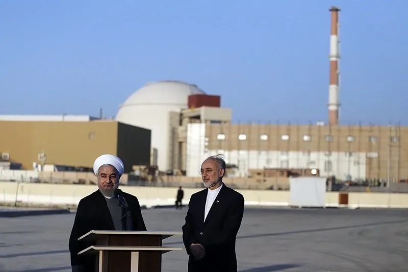 Iran Nuclear Threat visual showing Bushehr Nuclear Power Plant with Iranian officials inspecting the facility on the Persian Gulf coast