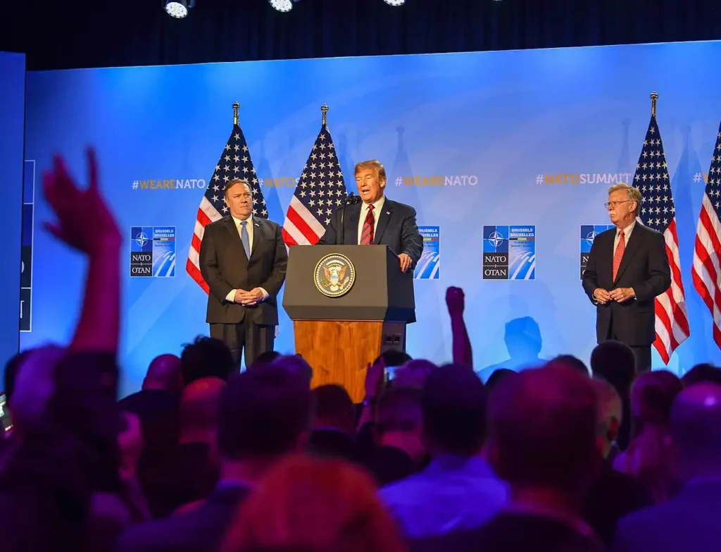 Donald Trump speaking at a NATO press conference in 2018 with US officials